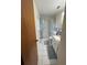 Bright bathroom features a shower with curtains, neutral tile flooring, and a vanity with ample storage at 704 Queens Ct, Seffner, FL 33584