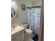 Bathroom featuring anchor shower curtain and sink with cabinets at 704 Queens Ct, Seffner, FL 33584