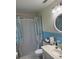 Bathroom with vanity, unique curtain, and white and blue tile at 704 Queens Ct, Seffner, FL 33584