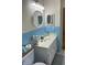 Bathroom vanity with blue tile, round mirror and square mirror at 704 Queens Ct, Seffner, FL 33584