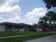 Charming single-story home with a well-maintained lawn and tidy landscaping features at 704 Queens Ct, Seffner, FL 33584