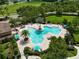 Beautiful aerial view of a resort-style pool area with palm trees, lounge chairs, and Gathering-friendly amenities at 1044 Oliveto Verdi Ct, Brandon, FL 33511