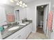 A well-lit bathroom featuring double sinks and a shower at 1044 Oliveto Verdi Ct, Brandon, FL 33511