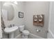 Well-lit half bathroom featuring a pedestal sink and neutral decor at 1044 Oliveto Verdi Ct, Brandon, FL 33511
