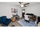 Bright, multifunctional room with a ceiling fan, room to create music, and a comfy armchair at 1044 Oliveto Verdi Ct, Brandon, FL 33511
