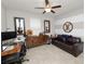 A versatile room with a stylish desk, sleek storage cabinet, and comfortable seating under a ceiling fan at 1044 Oliveto Verdi Ct, Brandon, FL 33511