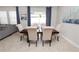 Dining area featuring a dark wood table, seating for six, and natural light at 1044 Oliveto Verdi Ct, Brandon, FL 33511