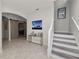 Bright foyer with an accent table and staircase leading to the upper level at 1044 Oliveto Verdi Ct, Brandon, FL 33511