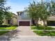 Charming two-story home with well-maintained landscaping and a brick driveway, creating inviting curb appeal at 1044 Oliveto Verdi Ct, Brandon, FL 33511