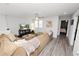 Spacious living room with light grey floors, stylish furniture, and bright natural light at 1044 Oliveto Verdi Ct, Brandon, FL 33511