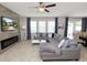 Inviting living room featuring a fireplace, large windows, and an open floor plan at 1044 Oliveto Verdi Ct, Brandon, FL 33511