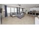 Spacious living room with large windows and an open layout to the kitchen and dining area at 1044 Oliveto Verdi Ct, Brandon, FL 33511