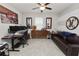 Modern office space with dark leather sofa and guitar-themed decor at 1044 Oliveto Verdi Ct, Brandon, FL 33511