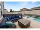 Inviting patio with comfortable seating around a firepit, overlooking a pool and spa for relaxing outdoor enjoyment at 1044 Oliveto Verdi Ct, Brandon, FL 33511