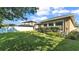 Expansive backyard with a manicured lawn, fenced perimeter, and covered outdoor living area at 11825 Frost Aster Dr, Riverview, FL 33579