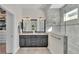 Elegant bathroom with dual sinks, granite counters, and a glass-enclosed shower with stone accents at 11825 Frost Aster Dr, Riverview, FL 33579