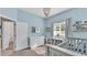 Light and airy Bedroom showcasing bright blue walls, decor, and plentiful storage at 11825 Frost Aster Dr, Riverview, FL 33579