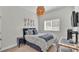 Comfortable bedroom featuring modern decor, a work space, and stylish honeycomb ceiling lamp at 11825 Frost Aster Dr, Riverview, FL 33579