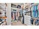 Well-organized walk-in closet with custom shelving, hanging racks, and ample storage space for clothes and accessories at 11825 Frost Aster Dr, Riverview, FL 33579