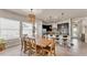 Open concept dining area with wooden table, pendant lighting, and a seamless flow to kitchen at 11825 Frost Aster Dr, Riverview, FL 33579