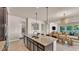 Large kitchen island with stainless steel appliances, granite countertops and open floor plan at 11825 Frost Aster Dr, Riverview, FL 33579