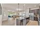 Spacious kitchen featuring an island and seamlessly connected to the dining and living areas at 11825 Frost Aster Dr, Riverview, FL 33579