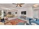 Open living room connecting to a dining area and kitchen, with a large TV, lots of seating and tile floors at 11825 Frost Aster Dr, Riverview, FL 33579