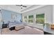 A light-filled bedroom features a large window, a comfortable bed, and ample space at 11825 Frost Aster Dr, Riverview, FL 33579