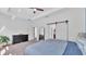 The main bedroom features a sliding barn door, carpet floors, and a ceiling fan at 11825 Frost Aster Dr, Riverview, FL 33579