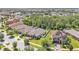Aerial view of homes in a suburban neighborhood with mature trees, green lawns, and a lake nearby at 11825 Frost Aster Dr, Riverview, FL 33579