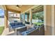 Inviting covered patio with comfortable seating, fan, and view of the fenced backyard at 11825 Frost Aster Dr, Riverview, FL 33579