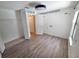 Bedroom featuring new floors, a ceiling fan, a closet, and an adjacent door at 12212 Hidden Brook Dr, Tampa, FL 33624