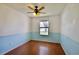 Well-lit bedroom with wood floors, two-tone walls and a ceiling fan at 12212 Hidden Brook Dr, Tampa, FL 33624