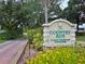 Signage for Country Run, a deed-restricted community with lush landscaping at 12212 Hidden Brook Dr, Tampa, FL 33624