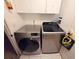 Convenient laundry room with modern washer and dryer, plus overhead storage at 12212 Hidden Brook Dr, Tampa, FL 33624