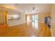 Bright living room with wood floors, slider doors to the pool, and eat-in kitchen at 12212 Hidden Brook Dr, Tampa, FL 33624