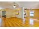 Bright, open-concept living space with hardwood floors seamlessly connects living, dining, and kitchen areas at 12212 Hidden Brook Dr, Tampa, FL 33624