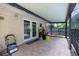 Screened patio offers outdoor living with tile flooring and access to the backyard at 12212 Hidden Brook Dr, Tampa, FL 33624