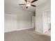 Bedroom featuring a ceiling fan, carpet flooring, and a view of an ensuite bathroom at 2422 White Ladyfish Rd, Wimauma, FL 33598