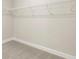 Spacious walk-in closet with wire shelving, carpet flooring, and ample storage space at 2422 White Ladyfish Rd, Wimauma, FL 33598
