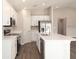 Bright kitchen with white cabinets, stainless steel appliances, and a large kitchen island at 2572 58Th E Cir, Palmetto, FL 34221