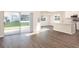 Open concept living area with sliding glass doors to backyard and adjacent kitchen at 2572 58Th E Cir, Palmetto, FL 34221