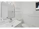 Bright bathroom with a modern sink, white tile, and a large mirror at 275 Garden Rd, Venice, FL 34293