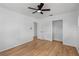 Spacious bedroom featuring wood floors, neutral walls, ceiling fan, and a closet at 275 Garden Rd, Venice, FL 34293