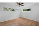 Bedroom with wood floors, neutral walls, ceiling fan, and bright windows at 275 Garden Rd, Venice, FL 34293