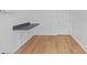 Bright room featuring light brown laminate wood flooring, a gray countertop, and a white door at 275 Garden Rd, Venice, FL 34293