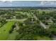 Aerial view of the home surrounded by lush trees and greenery, offering privacy and a serene setting at 2802 Midway Rd, Plant City, FL 33565