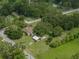 An overhead view of the property, highlighting the house, chicken coop, and lush landscaping at 2802 Midway Rd, Plant City, FL 33565