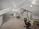 A spacious attic bedroom with neutral carpet, dormer window and an office setup at 2802 Midway Rd, Plant City, FL 33565