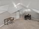 Finished attic features carpeted floors, neutral walls, and a workspace with a desk and chair, perfect for a home office at 2802 Midway Rd, Plant City, FL 33565